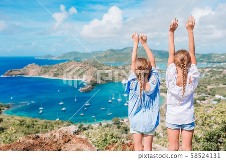 Adorable little kids enjoying the view of picturesque English Harbour at Antigua in caribbean sea Adorable little kids enjoying the view of picturesque English Harbour at Antigua in caribbean sea 58524131