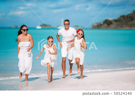 Young family of four on vacation have fun Young family of four on vacation have fun 58524140