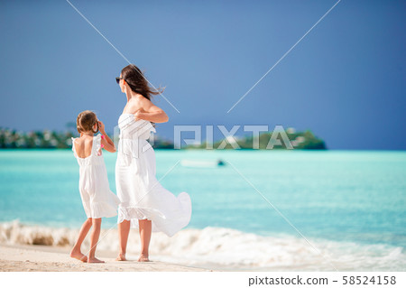 Beautiful mother and daughter on Caribbean beach Beautiful mother and daughter on Caribbean beach 58524158