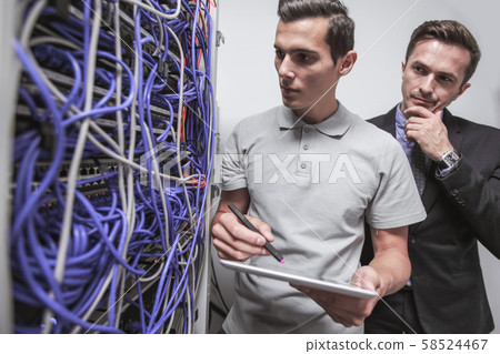 Engeneers in network server room Engeneers in network server room 58524467