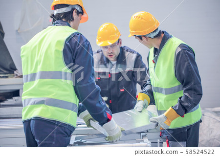 Workers taking aluminium billet Workers taking aluminium billet 58524522