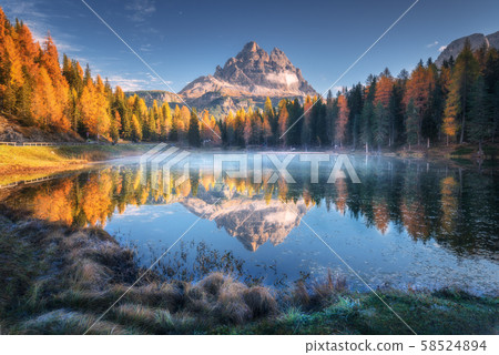 Lake with reflection of mountains at sunrise in autumn in Dolomites, Italy Lake with reflection of mountains at sunrise in autumn in Dolomites, Italy 58524894