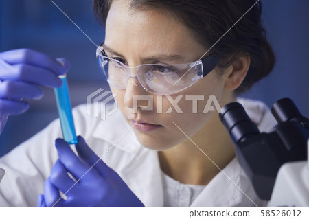 Female Scientist Studying Test Sample 58526012
