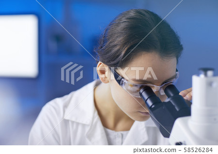 Female Lab Technician Looking in Microscope Female Lab Technician Looking in Microscope 58526284