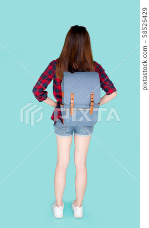 Back view of beautiful young asian woman travel with backpack isolated on blue background Back view of beautiful young asian woman travel with backpack isolated on blue background 58526429