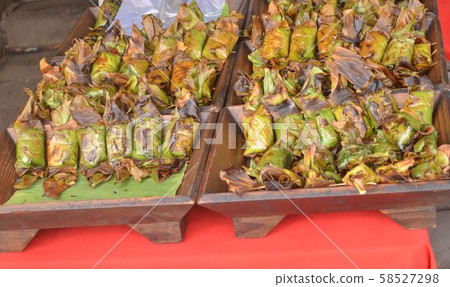 Thailand desserts wrapped in banana leaves. 58527298
