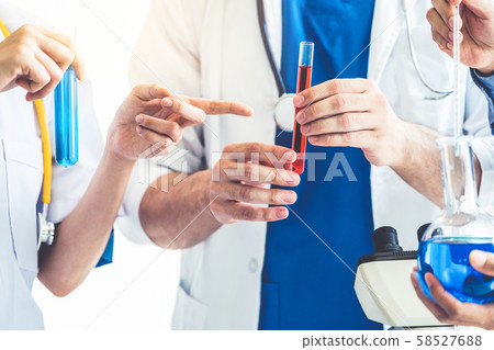 Group of scientists working in chemical lab. 58527688