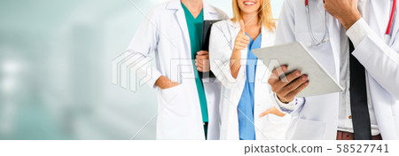 Doctor working in hospital with other doctors. Doctor working in hospital with other doctors. 58527741