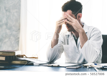 Doctor working in hospital office. Doctor working in hospital office. 58527806