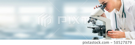 Scientist researcher uses microscope in laboratory 58527879