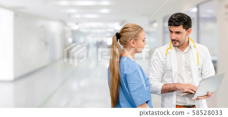 Doctors at hospital working with another doctor. Doctors at hospital working with another doctor. 58528033