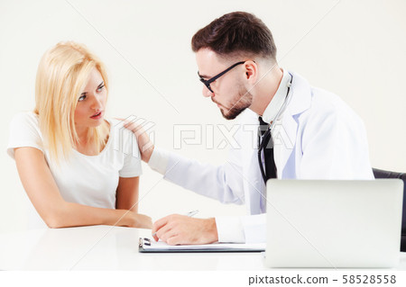 Male Doctor and Female Patient in Hospital Office 58528558