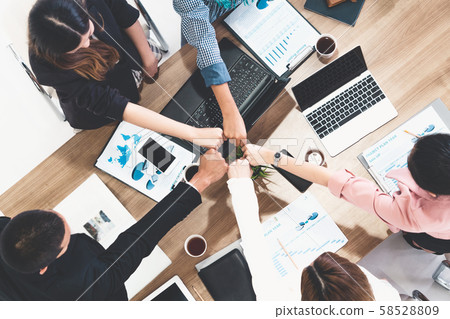 Teamwork business people join hands in meeting. 58528809
