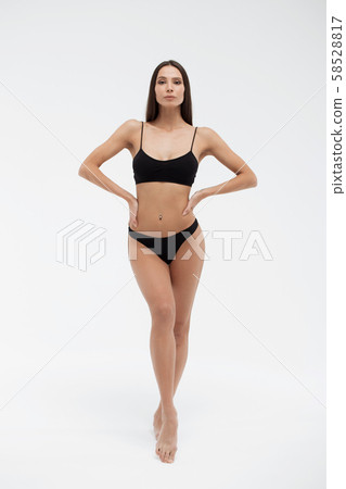 Sexy woman in underwear looking at camera Sexy woman in underwear looking at camera 58528817
