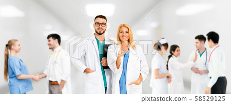 Doctor working in hospital with other doctors. 58529125