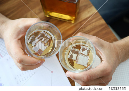 Glass of whiskey in office 58532565