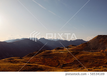 Beautiful alpine landscape with mountain range silhouette Beautiful alpine landscape with mountain range silhouette 58534189