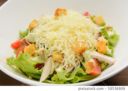Chicken salad with cheese and crackers on the white dish. Closeup 58536809