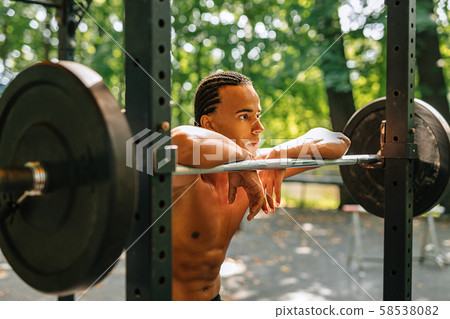 Exhausted kickboxer leaning on a punching bag Exhausted kickboxer leaning on a punching bag 58538082
