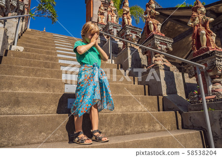 Young boy tourist in budhist temple Brahma Vihara Arama Bali Young boy tourist in budhist temple Brahma Vihara Arama Bali 58538204