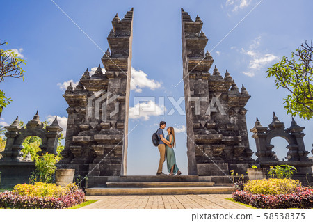 Loving couple of tourists in budhist temple Brahma Vihara Arama Banjar Bali, Indonesia. Honeymoon Loving couple of tourists in budhist temple Brahma Vihara Arama Banjar Bali, Indonesia. Honeymoon 58538375