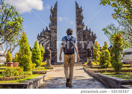 Young man tourist in budhist temple Brahma Vihara Arama Banjar Bali, Indonesia 58538387