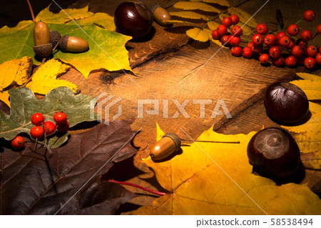 Frame of Autumn maple leaves on aged wood with copy space. Mockup for seasonal offers and holiday Frame of Autumn maple leaves on aged wood with copy space. Mockup for seasonal offers and holiday 58538494