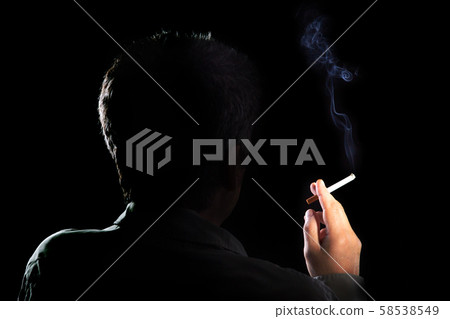 Mysterious man with cigarette and smoke isolated on a black background. Smoking kills. concept of 58538549