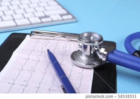 Medical stethoscope lying on cardiogram chart closeup. Medical help, prophylaxis, disease prevention Medical stethoscope lying on cardiogram chart closeup. Medical help, prophylaxis, disease prevention 58538551