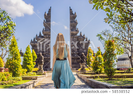 Young woman tourist in budhist temple Brahma Vihara Arama Banjar Bali, Indonesia 58538552