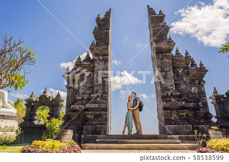 Loving couple of tourists in budhist temple Brahma Vihara Arama Banjar Bali, Indonesia. Honeymoon Loving couple of tourists in budhist temple Brahma Vihara Arama Banjar Bali, Indonesia. Honeymoon 58538599