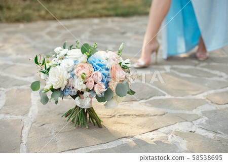 Gorgeous bouquet of roses, hydrangeas, ozotamnusa,eucalyptus on a beautiful concrete path 58538695