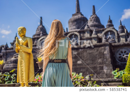 Young woman tourist in budhist temple Brahma Vihara Arama Banjar Bali, Indonesia Young woman tourist in budhist temple Brahma Vihara Arama Banjar Bali, Indonesia 58538741