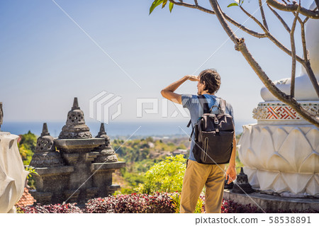 Young man tourist in budhist temple Brahma Vihara Arama Banjar Bali, Indonesia Young man tourist in budhist temple Brahma Vihara Arama Banjar Bali, Indonesia 58538891