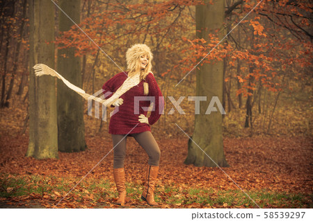 Fashion woman in windy fall autumn park forest. Fashion woman in windy fall autumn park forest. 58539297