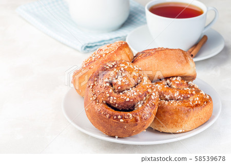 Cinnamon buns on a white plate Cinnamon buns on a white plate 58539678