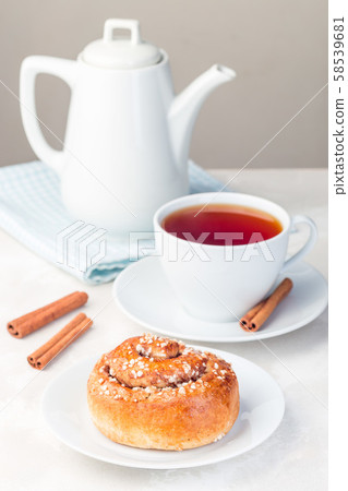 One cinnamon bun on a white plate One cinnamon bun on a white plate 58539681