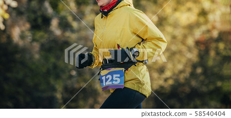 woman runner in yellow jacket woman runner in yellow jacket 58540404
