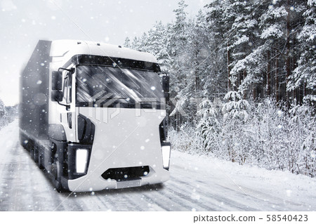 Truck rides on winter road in snowfall Truck rides on winter road in snowfall 58540423