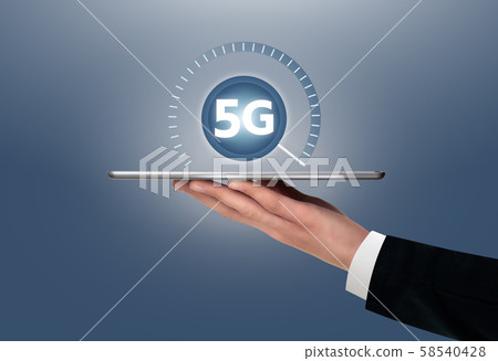 Man holding a digital tablet with symbol of 5G network connection. Man holding a digital tablet with symbol of 5G network connection. 58540428