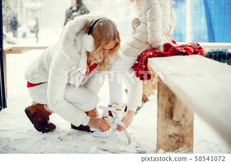 Cute and beautiful family in a winter city Cute and beautiful family in a winter city 58541072