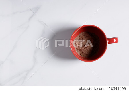 Red ceramic cups of hot cocoa on top of white Red ceramic cups of hot cocoa on top of white 58541499