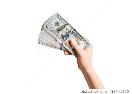 Female hand holding a fan of dollar banknotes on Female hand holding a fan of dollar banknotes on 58541500