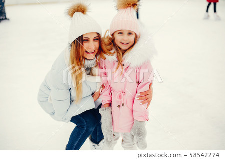 Cute and beautiful family in a winter city Cute and beautiful family in a winter city 58542274