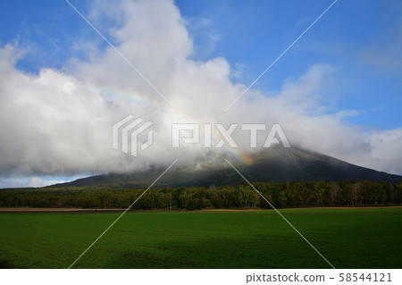 Shooting clouds and rainbow over Mt. Yotei (Mt. Fuji) in Makkari Village, Hokkaido Shooting clouds and rainbow over Mt. Yotei (Mt. Fuji) in Makkari Village, Hokkaido 58544121