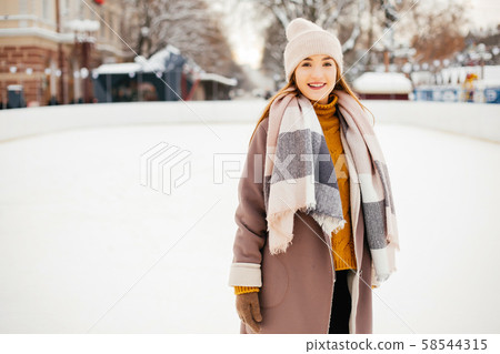 Cute and beautiful girl in a winter city Cute and beautiful girl in a winter city 58544315