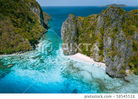 El Nido, Palawan, Philippines. Aerial view of tropical sea stack Island with tourist boats moored at El Nido, Palawan, Philippines. Aerial view of tropical sea stack Island with tourist boats moored at 58545518