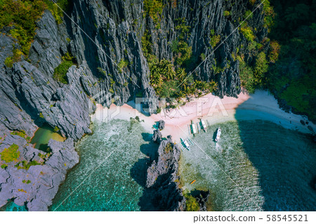 El Nido, Palawan, Philippines. Aerial view of Secret hidden lagoon beach with tourist banca boats on El Nido, Palawan, Philippines. Aerial view of Secret hidden lagoon beach with tourist banca boats on 58545521