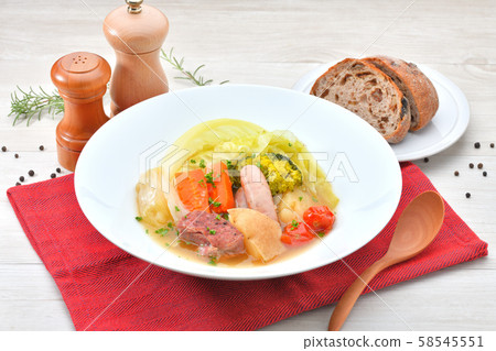 Potato, a stewed soup with vegetables, sausages and pork shoulder blocks. 58545551