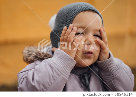 Baby girl surprised with hands on her head. Outddors winter day. Wow Baby girl surprised with hands on her head. Outddors winter day. Wow 58546114
